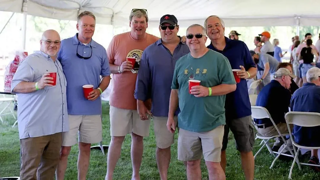 Group of men holding red cups